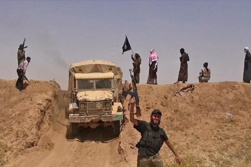 An image from a jihadist Twitter account shows what it says are militants on a road from...