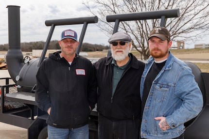 Roy Hutchins (center), who founded Hutchins Barbeque, stands with his eldest son Wesley...