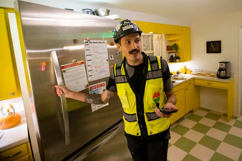 Will Heron of Dallas, artist liaison for Meow Wolf Grapevine, opened a refrigerator door...