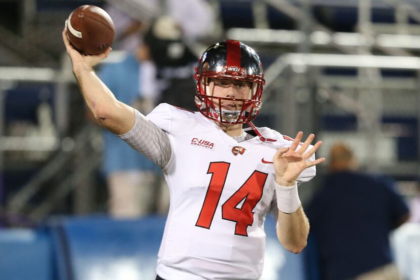 MIAMI, FL - NOVEMBER 24: Mike White #14 of the Western Kentucky Hilltoppers throws the ball...