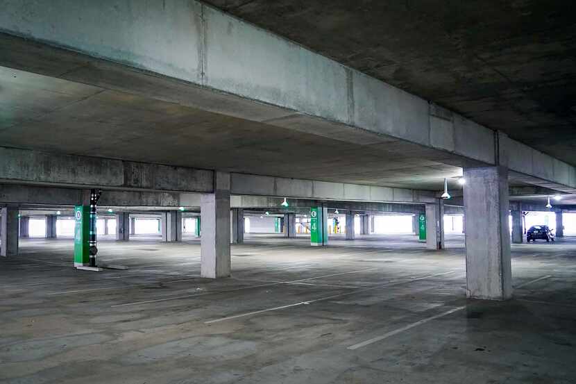 A lone parked car sits on a mostly empty floor of Garage C at Dallas Love Field on Friday,...
