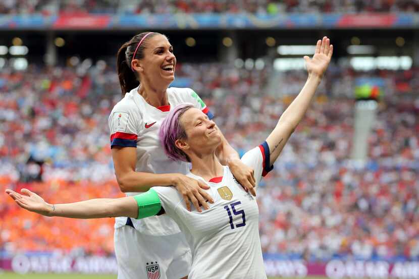 United States' Megan Rapinoe, right, celebrates after scoring the opening goal from the...