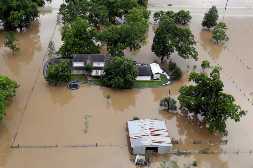 A home is surrounded by floodwaters on June 4 near Holiday Lakes, Texas. Parts of Texas have...