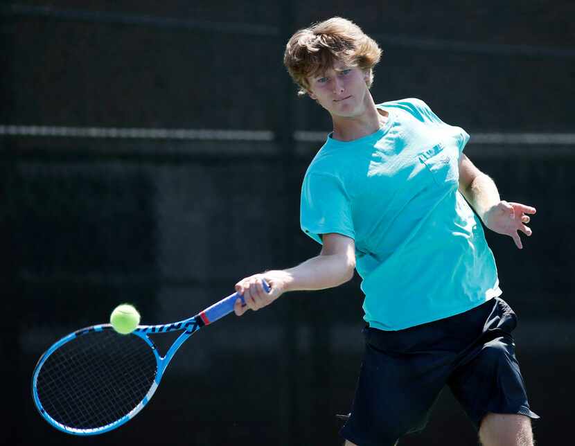 Highland Park's Cole Burnam hits the ball during tennis practice at Seay Tennis Center in...