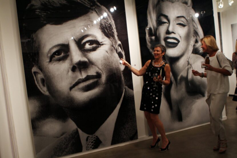 Christie Reniger and Beth Ewing (right) reacted to art by Alex Guofengcao during a pre-party...