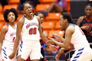 Duncanville junior guard Zarielle Green (00) celebrates drawing a foul against South Grand...