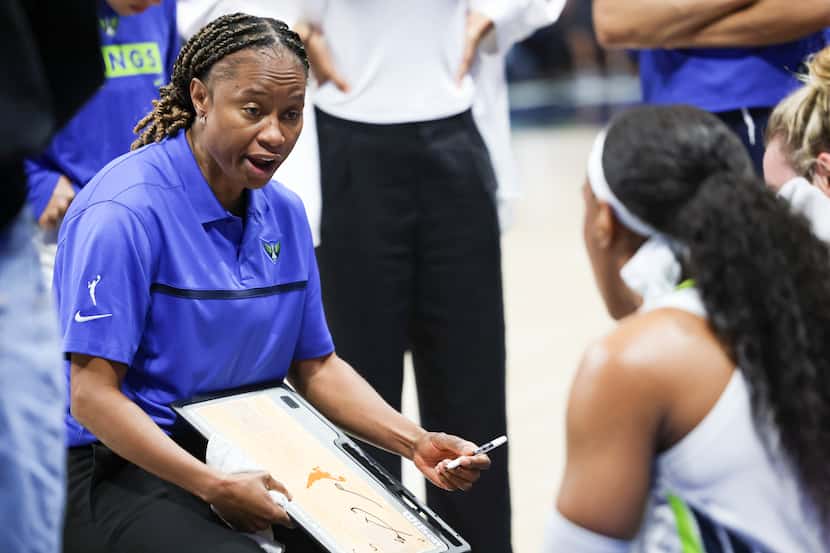 Dallas Wings Head Coach Vickie Johnson talks with players during a break in play in the...