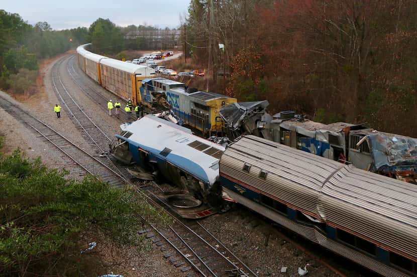 Authorities investigate the scene of a fatal Amtrak train crash in Cayce, South Carolina,...