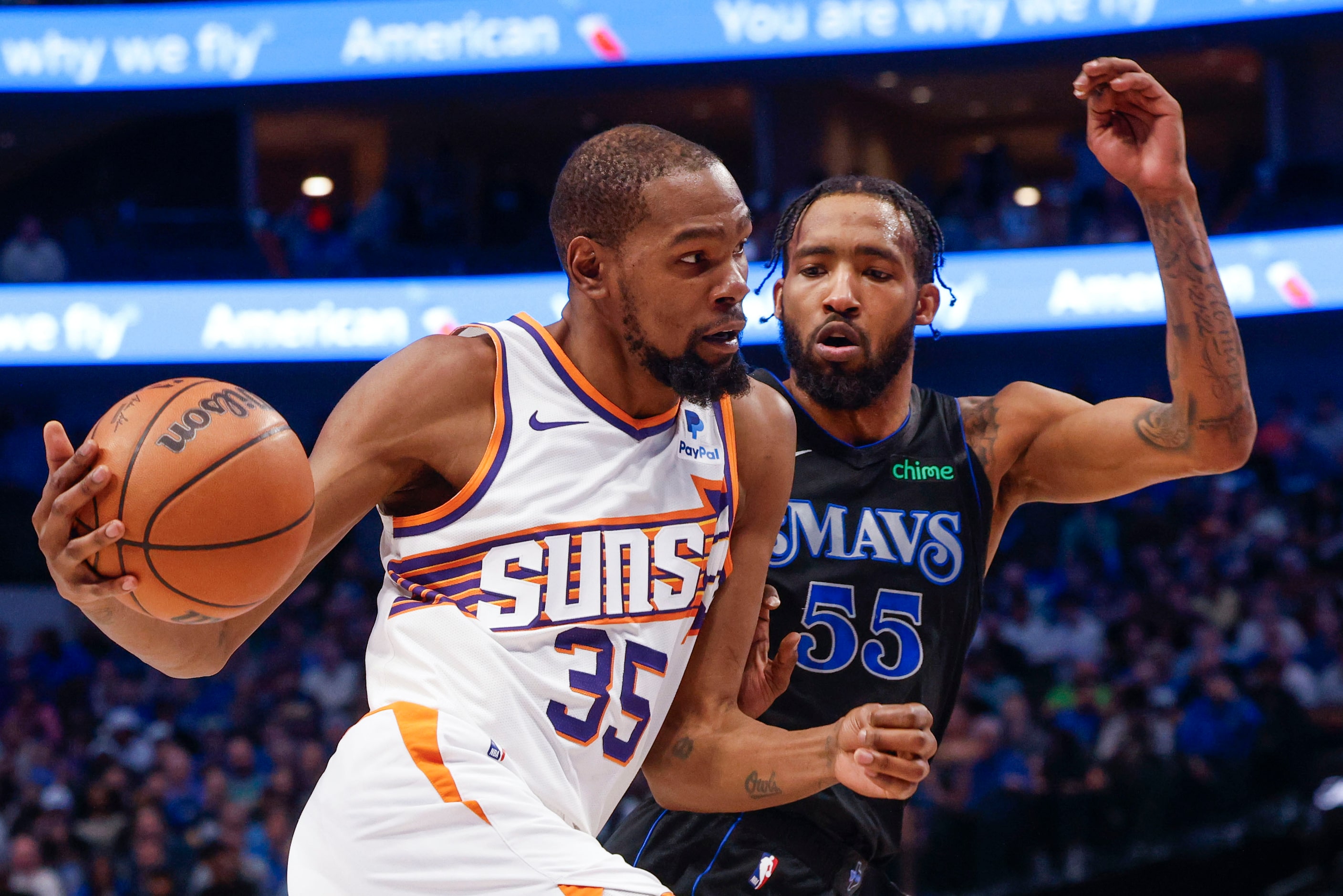 Phoenix Suns' Kevin Durant (35) dribbles past Dallas Mavericks forward Derrick Jones Jr....