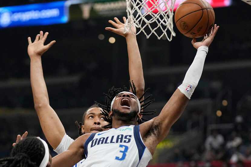 Dallas Mavericks guard Jaden Hardy, right, shoots as Los Angeles Clippers center Moses Brown...