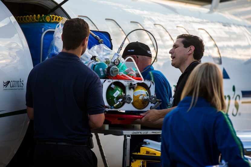 Paramedics transport one of ten babies in a Neonatal Intensive Care Unit from a Cook...