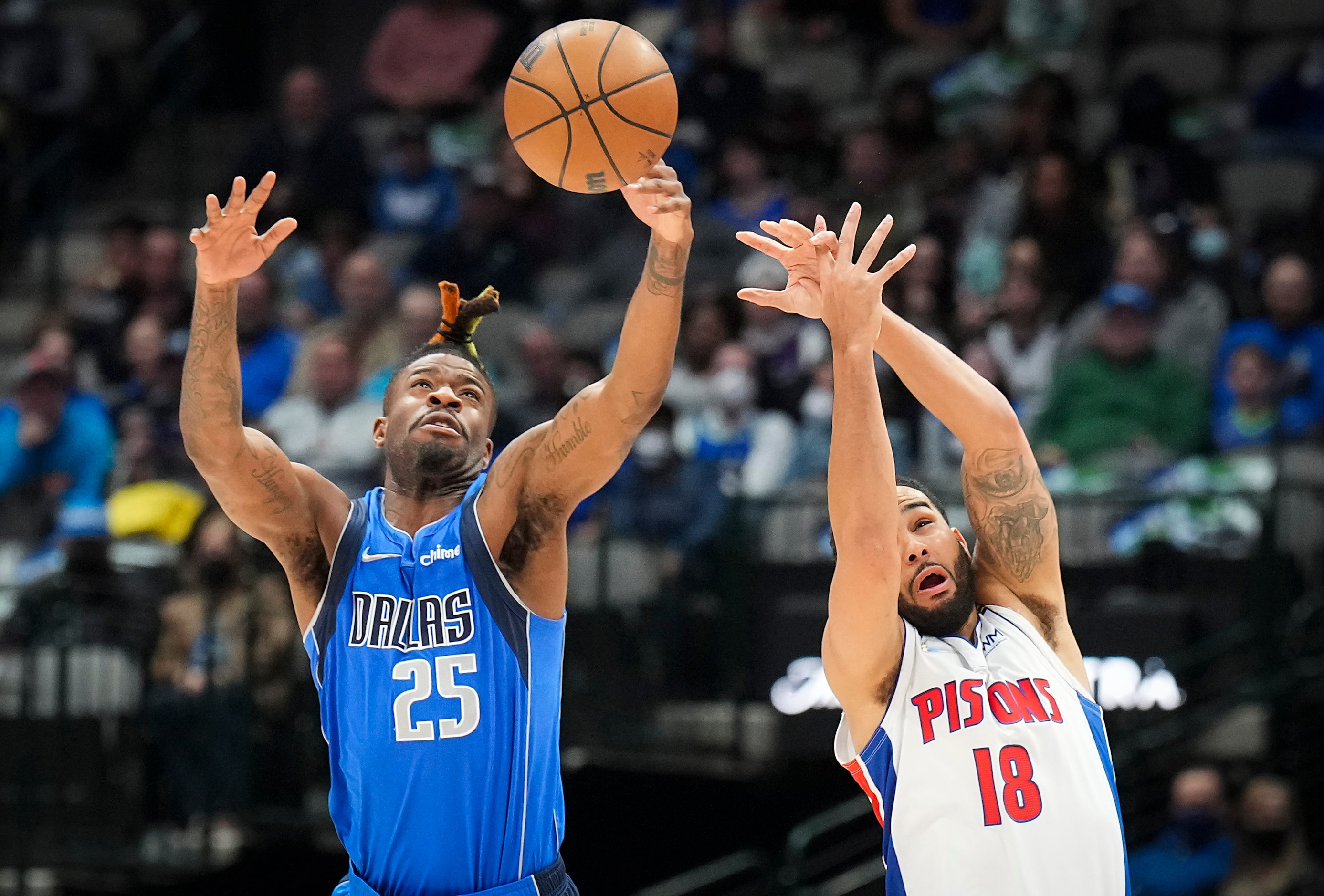 Dallas Mavericks forward Reggie Bullock (25) knocks the ball away from Detroit Pistons guard...