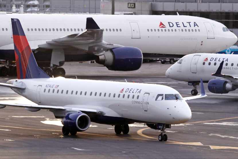 A Delta Connection Embraer 175 aircraft taxis to a gate at Logan International Airport in...