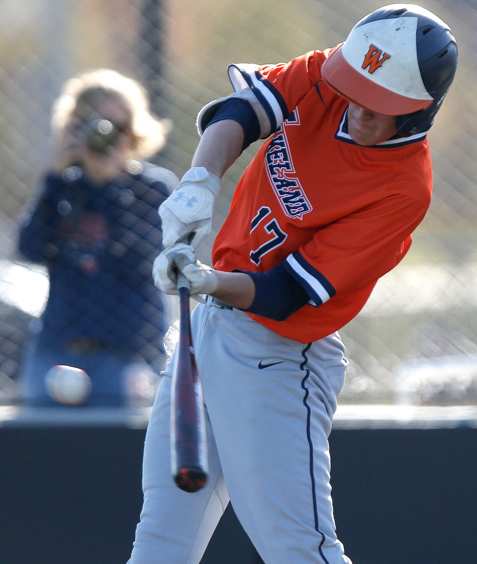 Wakeland third baseman Nick Miller (17) makes contact in the fourth inning as Heritage High...