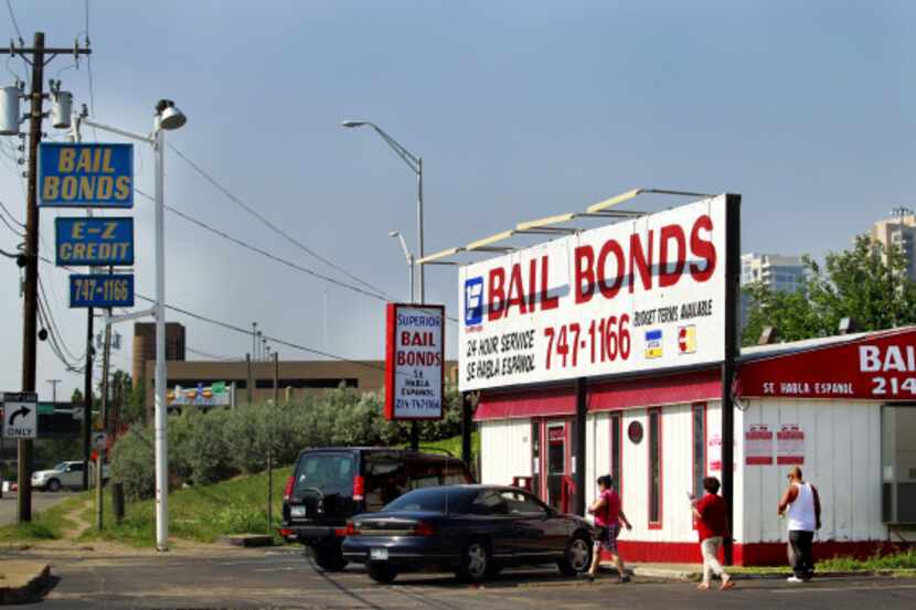 Bail bond offices advertise around-the-clock help on Riverfront Boulevard in Dallas.
