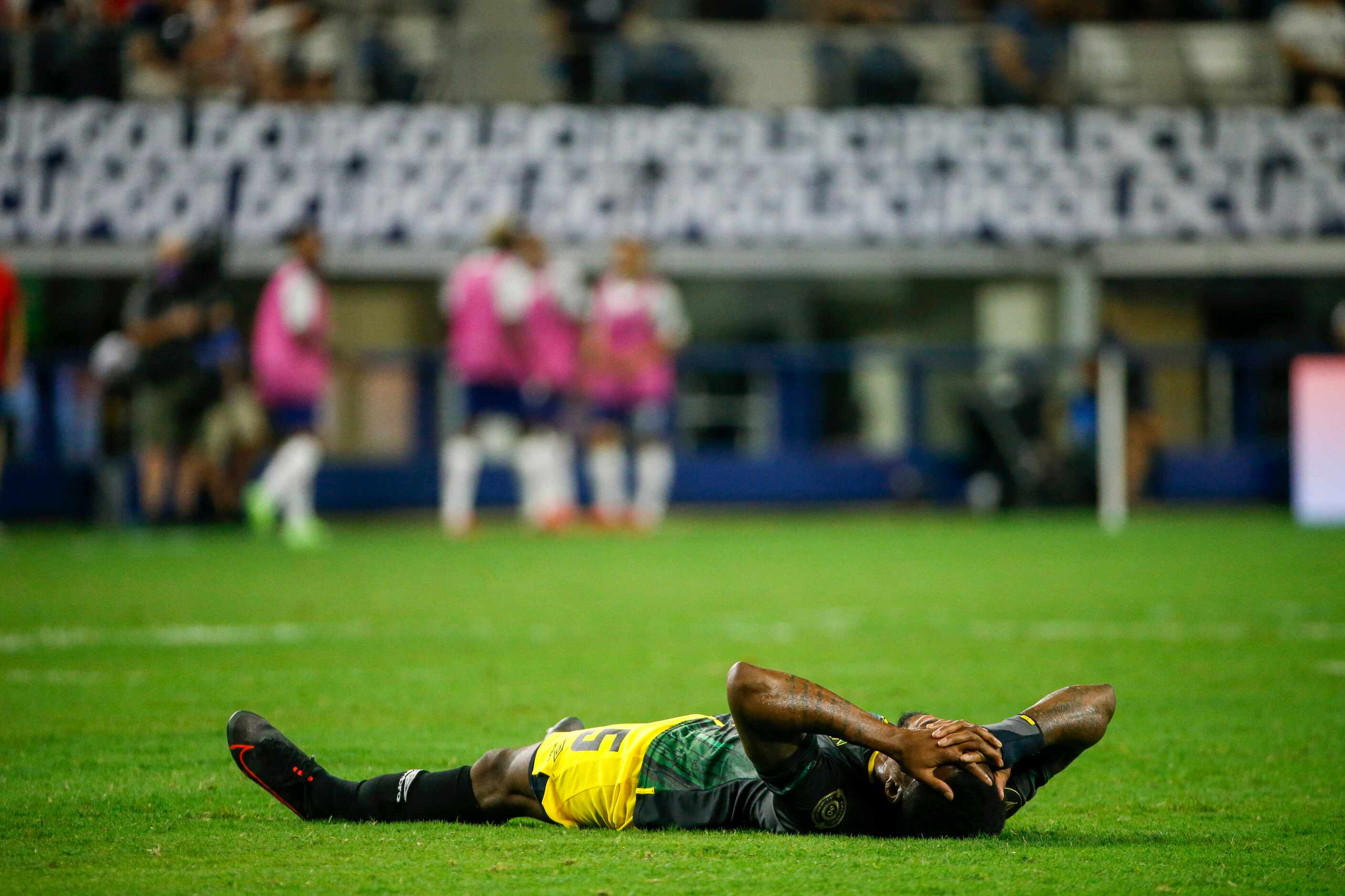 Jamaica defender Alvas Powell (5) lays on the ground injured during the first half of a...