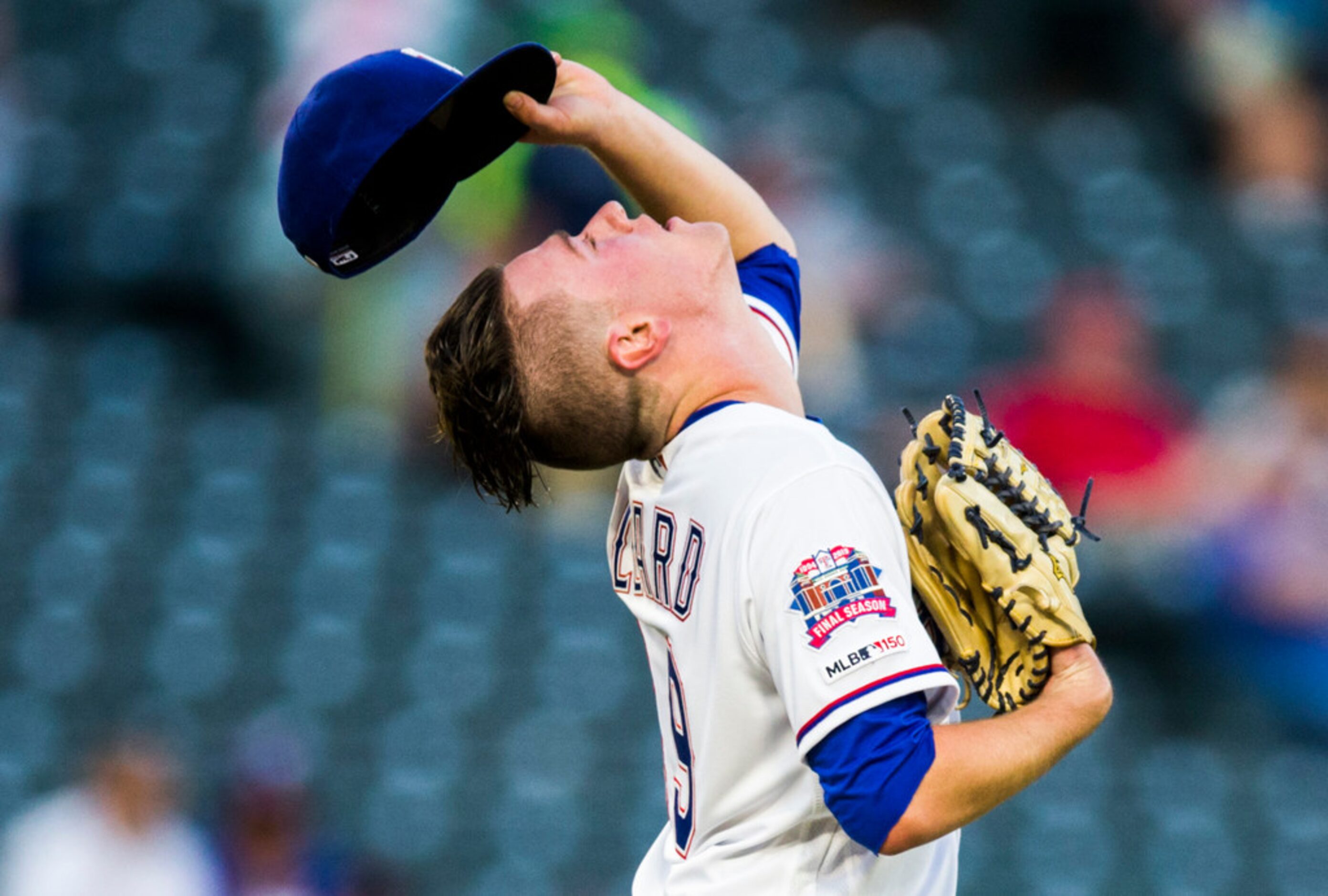 Texas Rangers starting pitcher Kolby Allard (39) adjusts his hair under his cap during the...