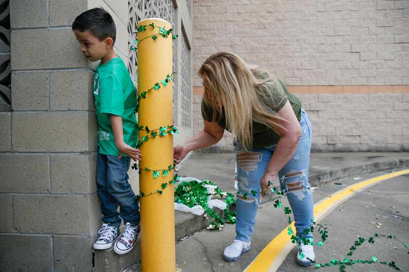 With her son Joel Guerrero's, 6, left, help Veronica Gutierrez, right, mother of Destiny...