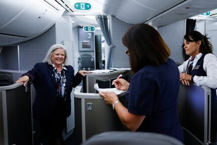 Cabin crews of an American Airlines Boeing 777 flight to Amsterdam engage in conversation on...