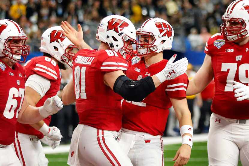 Wisconsin Badgers quarterback Alex Hornibrook (12) congratulates tight end Troy Fumagalli...