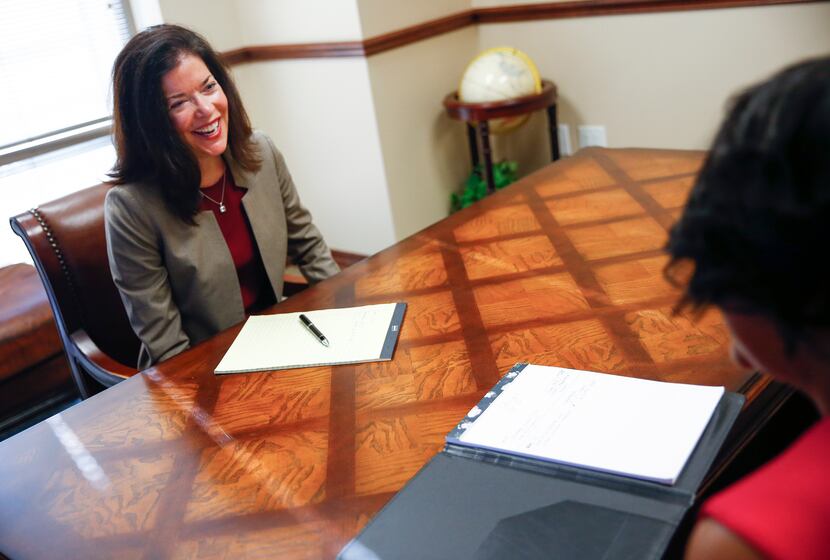 Kelli Poremba, left, meets with Sharby Hunt-Hart at Edward Jones Investments. Poremba, the...