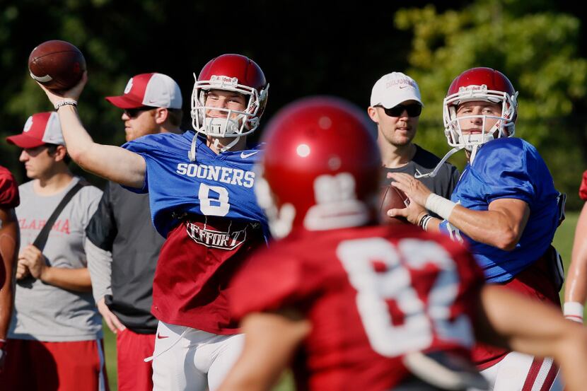 Oklahoma quarterbacks Tanner Schafer, left, and Austin Kendall, right, throw during an NCAA...