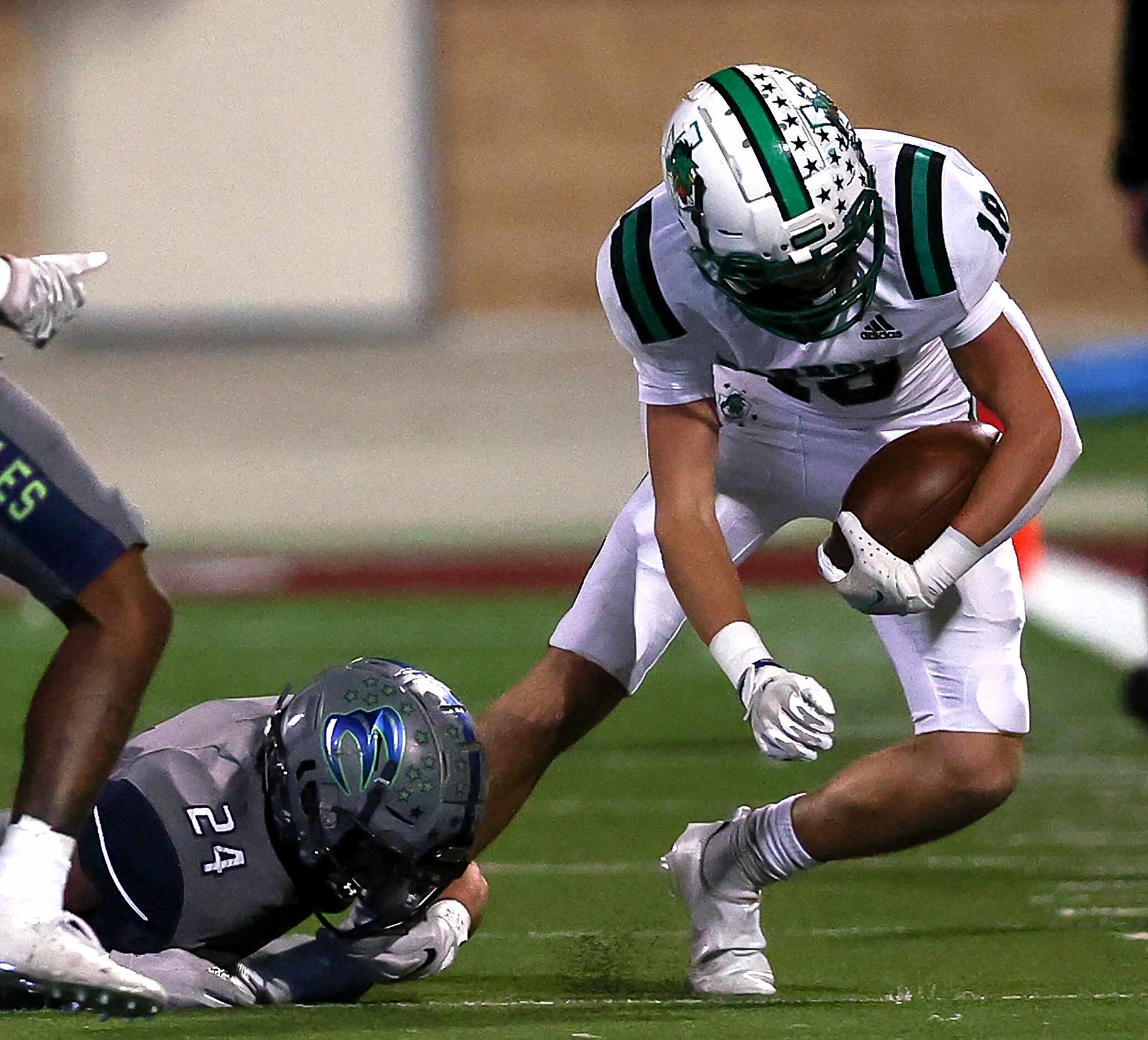 Southlake Carroll wide receiver Jake Whillock (18) comes up with a reception and is brought...
