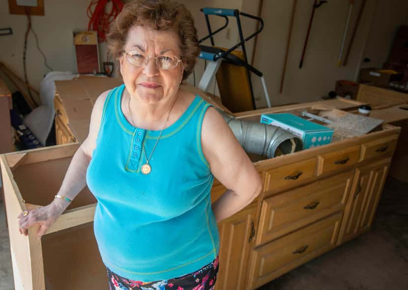 Because her kitchen cabinets are in her garage, all of her food items are stored in boxes in...