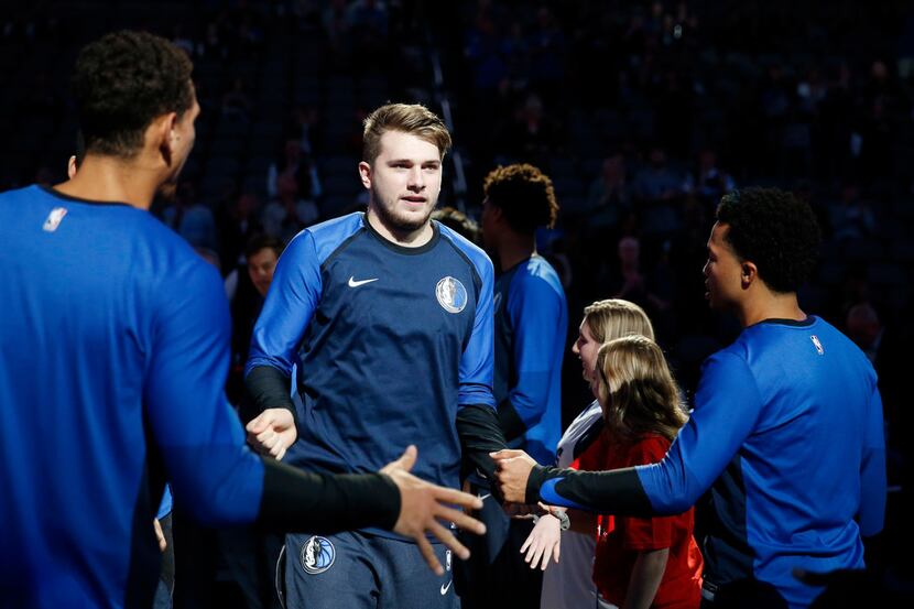 FILE - Dallas Mavericks guard Luka Doncic (77) makes his way onto the court as he is...