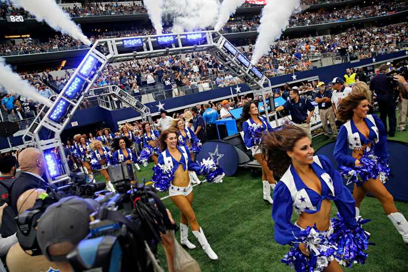 The Dallas Cowboys cheerleaders run on the field before a 39-28 loss to the Atlanta Falcons...