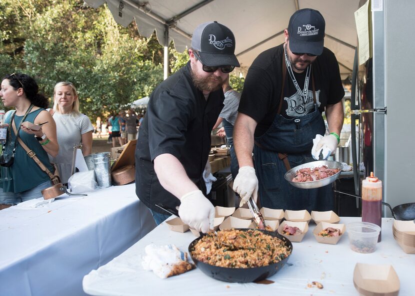 Rapscallion's chef de cuisine Brian Casner and executive chef Nathan Tate prepare beef...