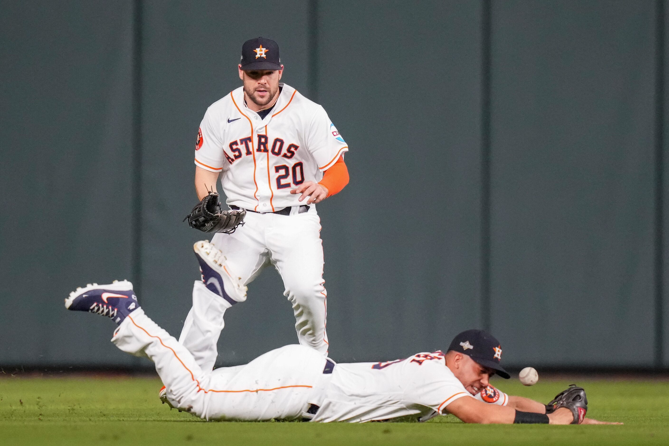 Houston Astros left fielder Michael Brantley (23) can’t make a diving catch as center...