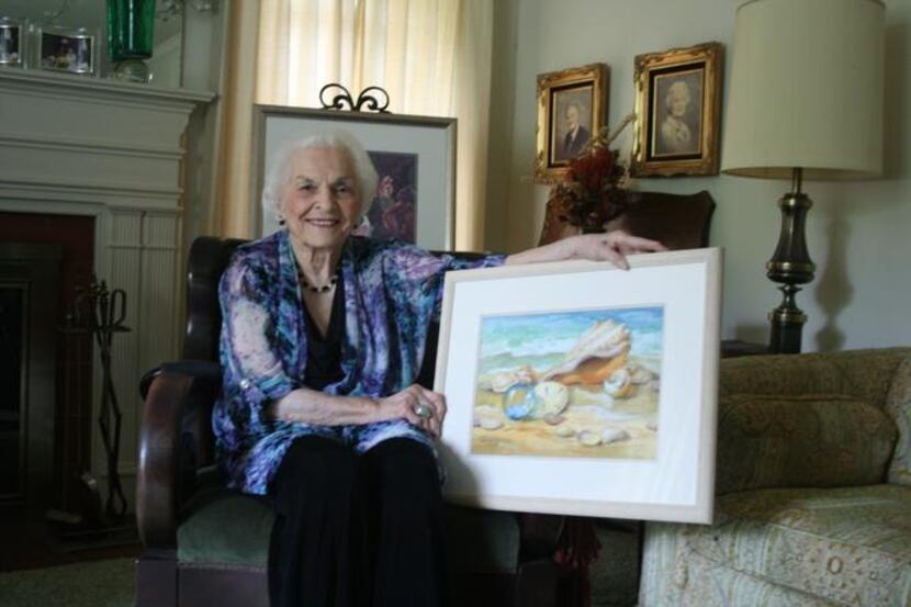 
Lucille Cummings, 100, paints watercolors at her kitchen table in Lakewood. One of her...