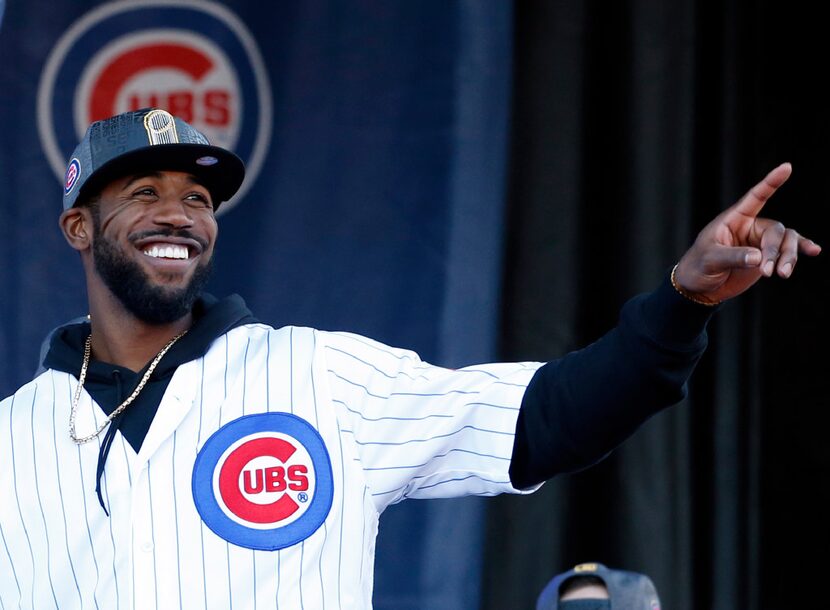 Chicago Cubs' Dexter Fowler smiles as he points during a celebration honoring the World...