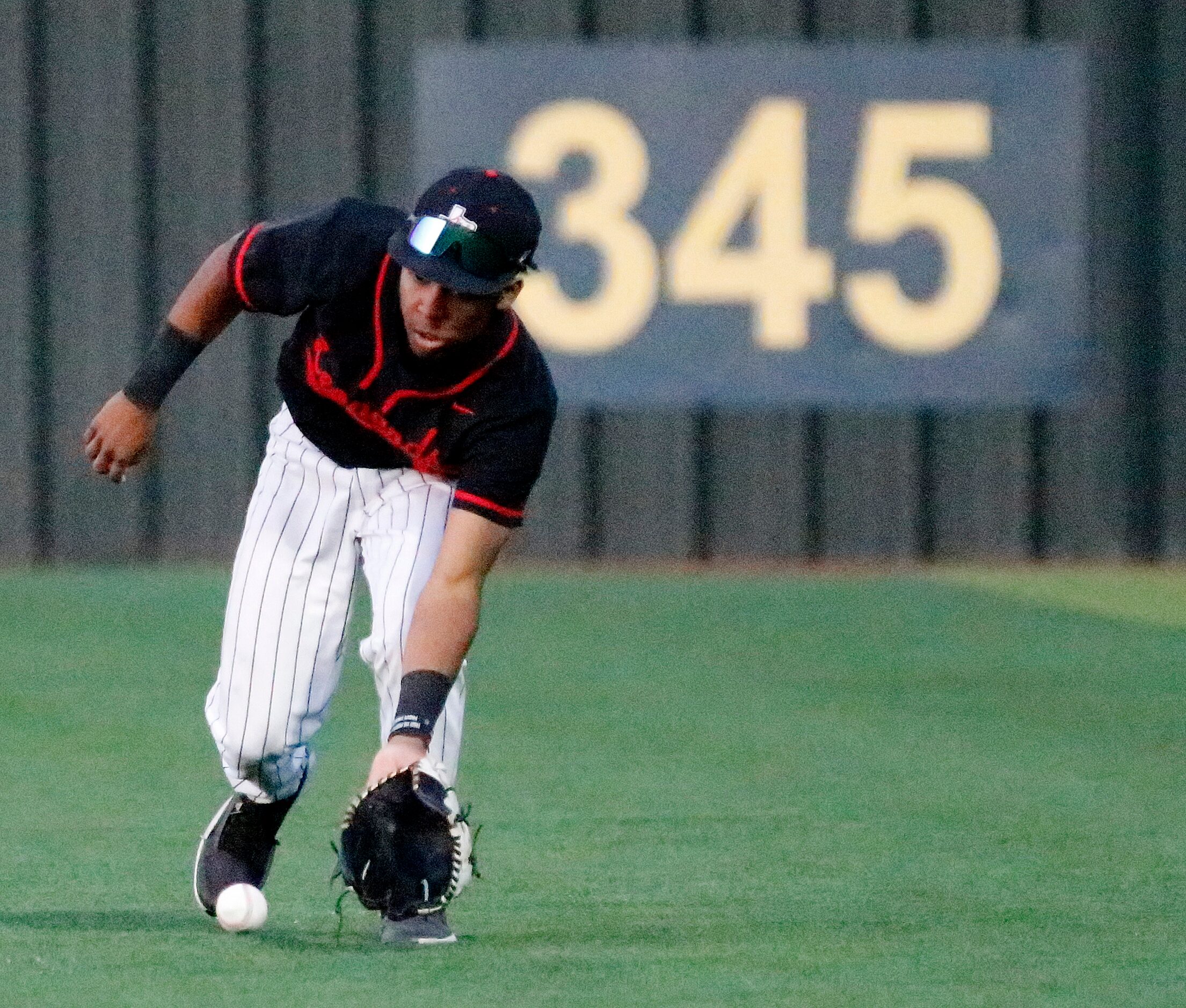 Lovejoy High School right fielder Aarren Marshall (8) fields a hit in the second inning as...