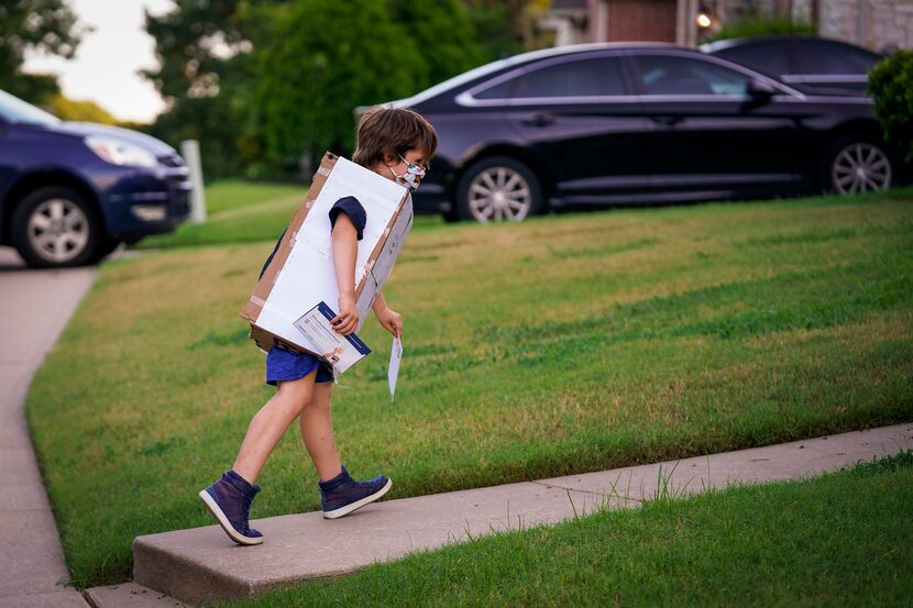 Jeffrey Carlton heads back indoors after gathering the mail during the family's quarantine...