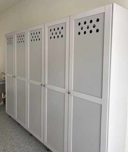 Cabinets fashioned to look and function like gym lockers to hold sports equipment.