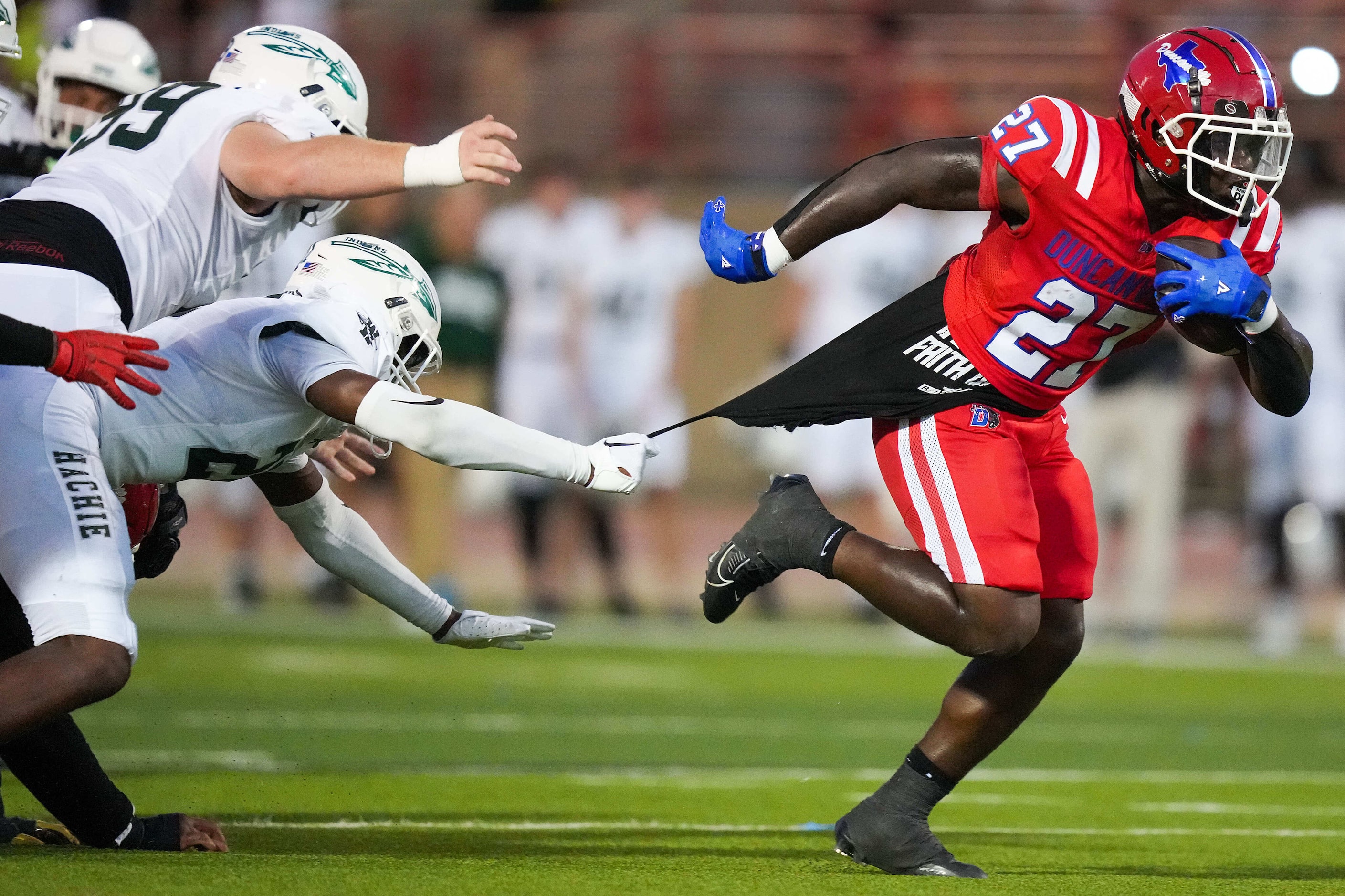 Duncanville running back JaQualon Armstrong (27) slips away from Waxahachie linebacker ...