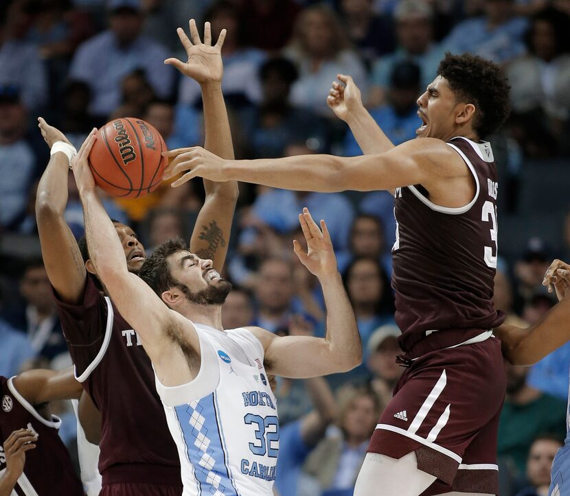 Texas A&M's Tyler Davis, right, blocks a shot by North Carolina's Luke Maye (32) during the...