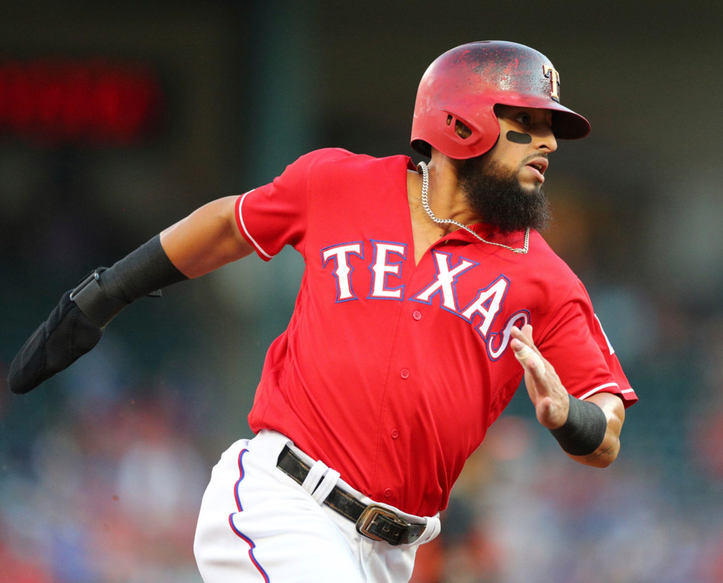 Texas Rangers' Rougned Odor rounds third base on the way to score on a throwing error by the...