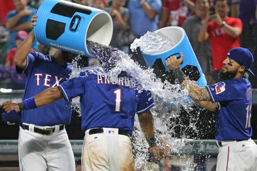 Texas Rangers shortstop Elvis Andrus (1) gets the water treatment after the the Seattle...