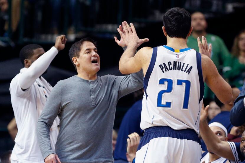  Dallas Mavericks owner Mark Cuban celebrates with center Zaza Pachulia (27) during the...