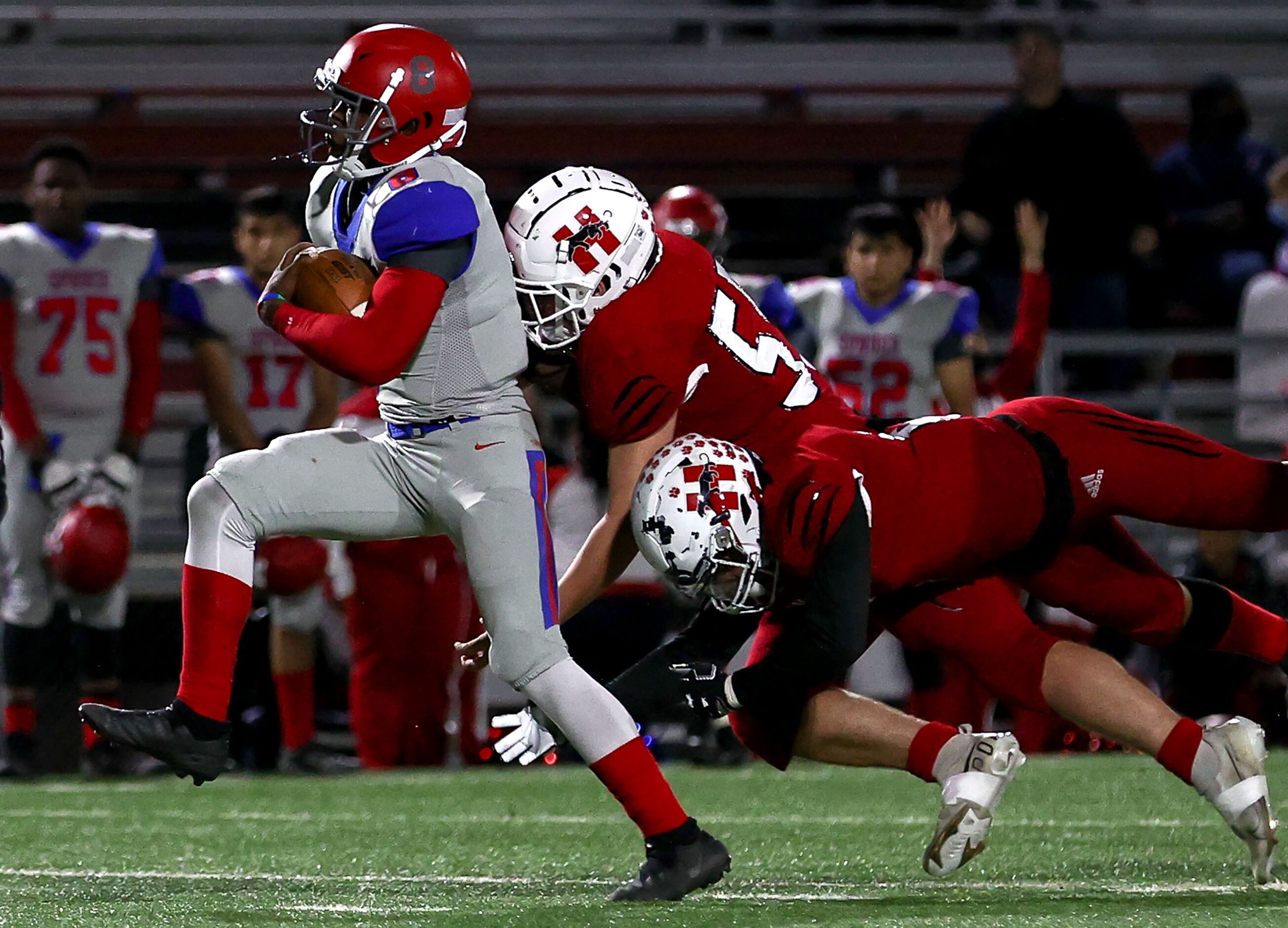 Spruce quarterback Kelvin Jones (8) gets past Hillcrest defensive lineman Leland Mayor (55)...