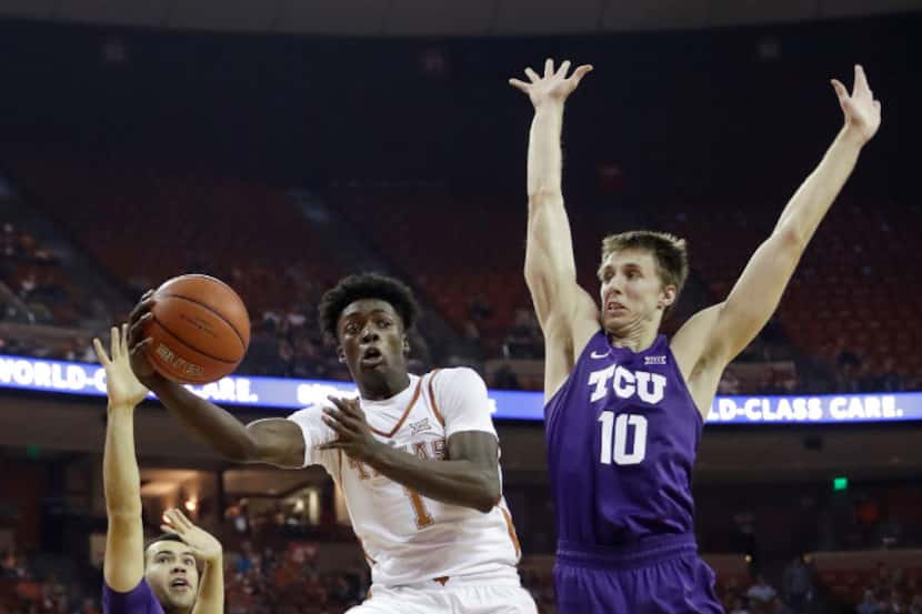 Texas guard Andrew Jones (1) drives past TCU forward Vladimir Brodziansky (10) during the...