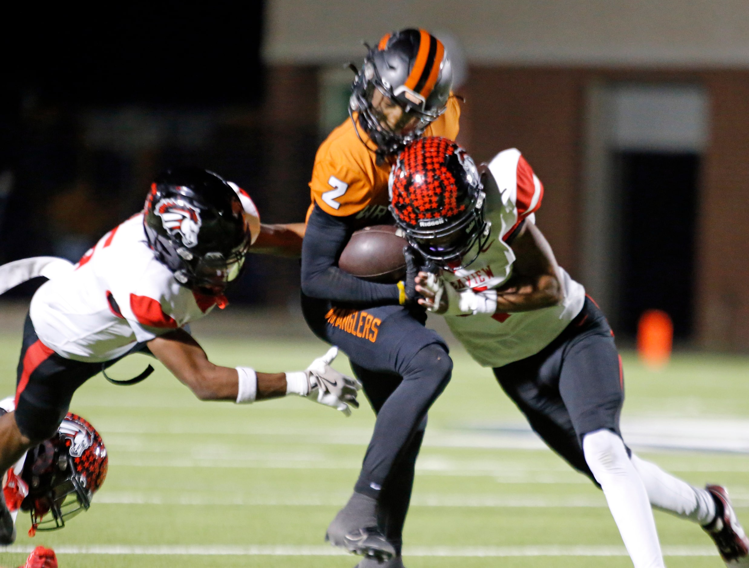 West Mesquite High’s Greg Gipson II (2) loses the football after being hit hard by a...