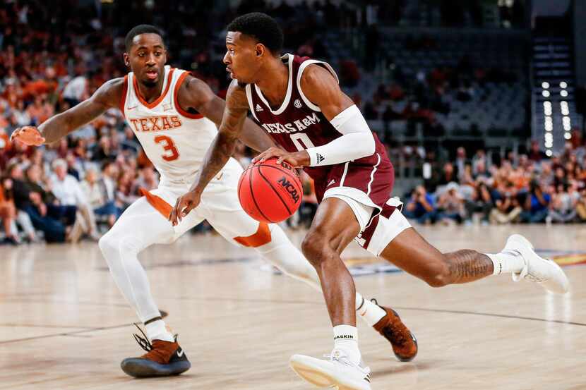 Texas A&M Aggies guard Jay Jay Chandler (0) drives past Texas Longhorns guard Courtney Ramey...