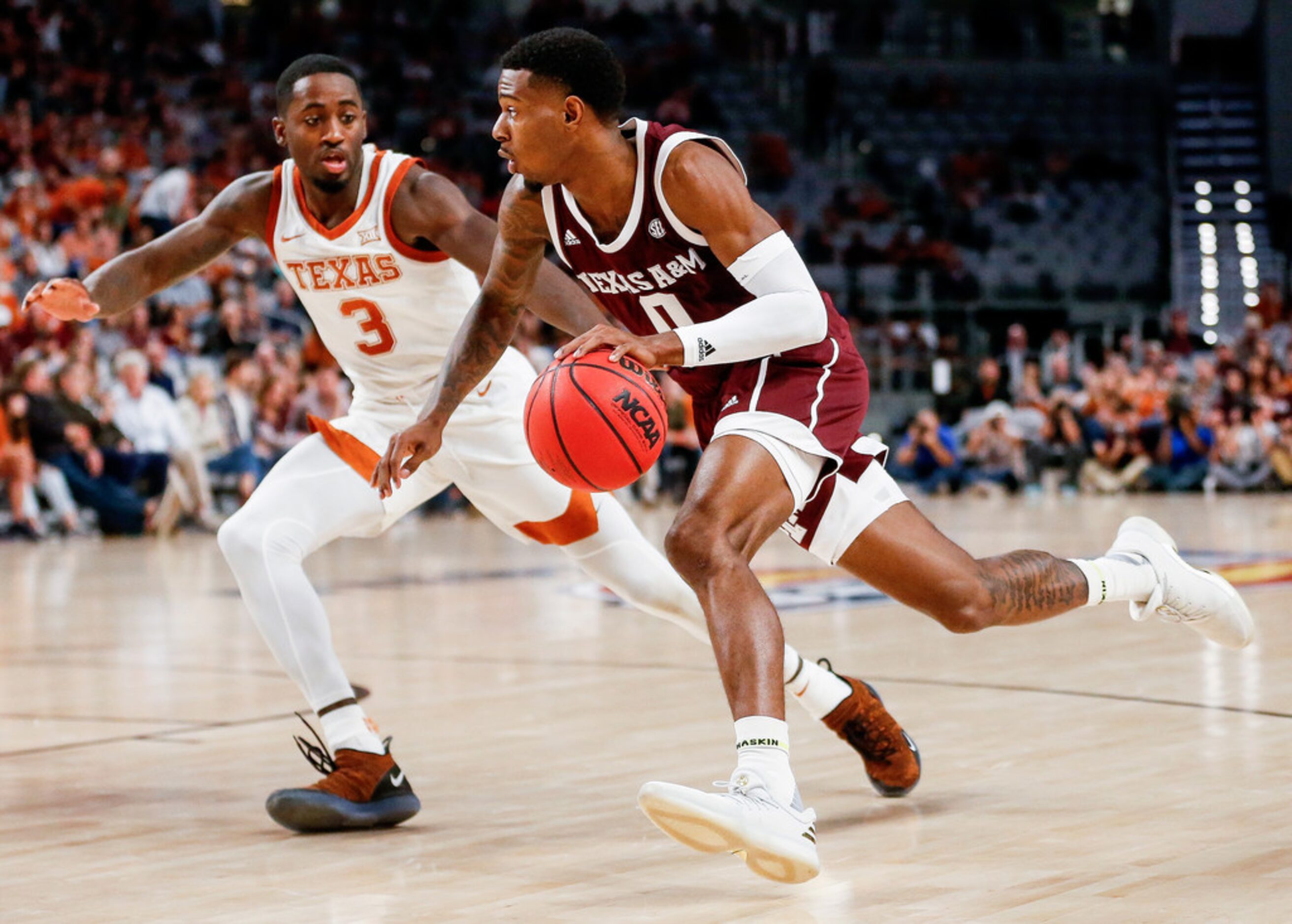 Texas A&M Aggies guard Jay Jay Chandler (0) drives past Texas Longhorns guard Courtney Ramey...