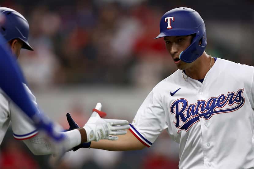 Mark Mathias (9) of the Texas Rangers rounds the bases after hitting a solo home run against...