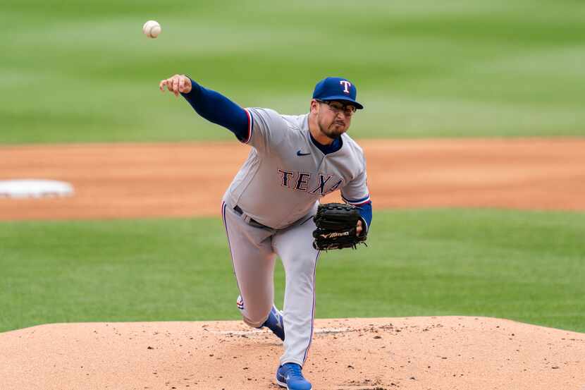 Texas Rangers starting pitcher Dane Dunning delivers during the first inning of a baseball...
