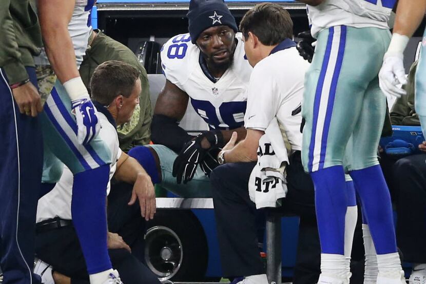 Dallas Cowboys wide receiver Dez Bryant (88) talks to the medical staff as they focus on his...